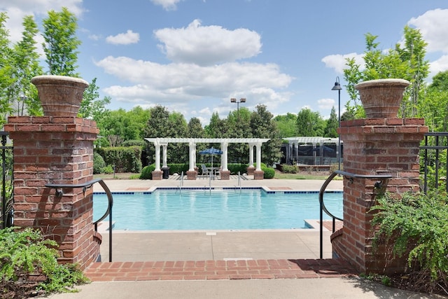 view of pool with a pergola and a patio area