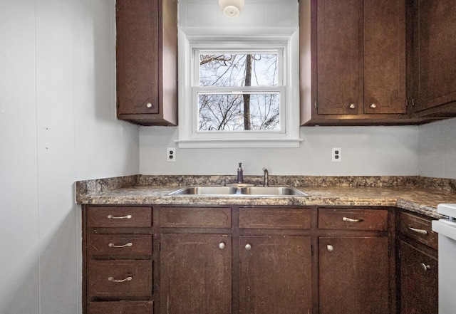 kitchen featuring dark brown cabinetry and sink