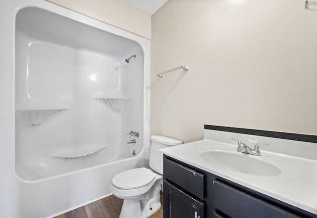 full bathroom with wood-type flooring, shower / washtub combination, vanity, and toilet