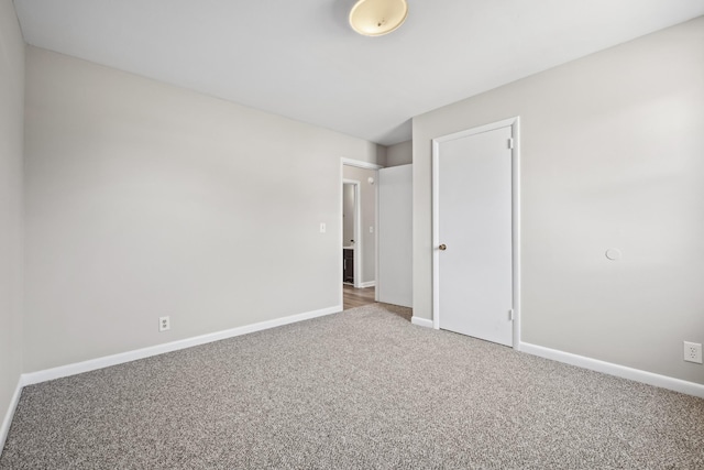 unfurnished bedroom with a closet and carpet flooring