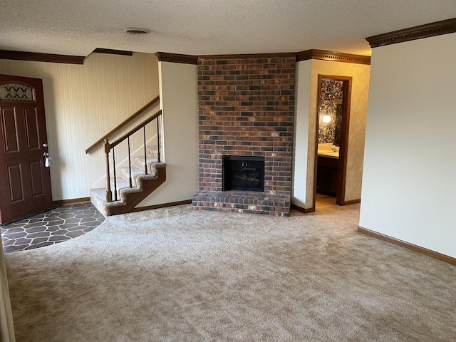 unfurnished living room featuring crown molding, a brick fireplace, carpet floors, and a textured ceiling