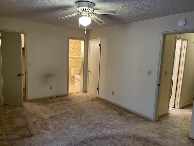 unfurnished bedroom with light carpet, connected bathroom, a textured ceiling, and ceiling fan