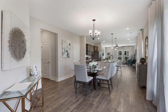 dining space featuring an inviting chandelier and dark hardwood / wood-style floors