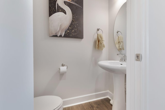 bathroom with toilet and hardwood / wood-style floors