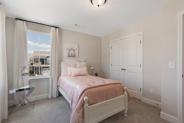 bedroom with light colored carpet and a closet