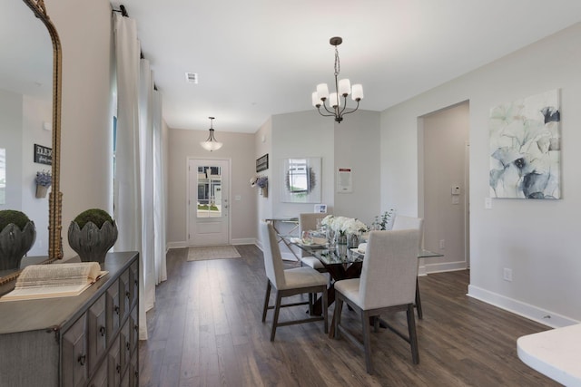 dining space featuring a notable chandelier and dark hardwood / wood-style floors