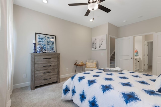 carpeted bedroom with connected bathroom and ceiling fan