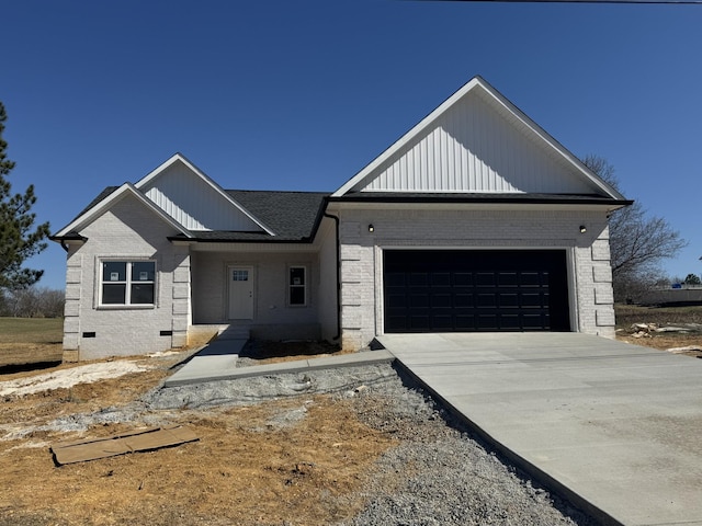 view of front of home featuring a garage, concrete driveway, brick siding, and crawl space