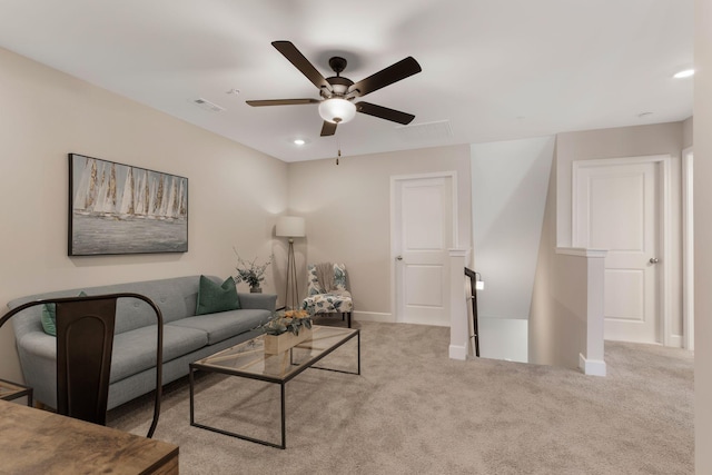 carpeted living room with ceiling fan