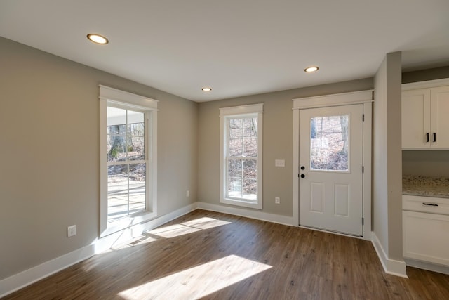 doorway to outside featuring plenty of natural light and light hardwood / wood-style floors