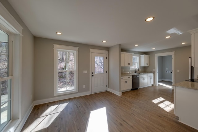 kitchen featuring white cabinetry, sink, light hardwood / wood-style flooring, and dishwasher