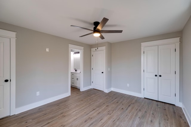 unfurnished bedroom with connected bathroom, ceiling fan, and light hardwood / wood-style flooring