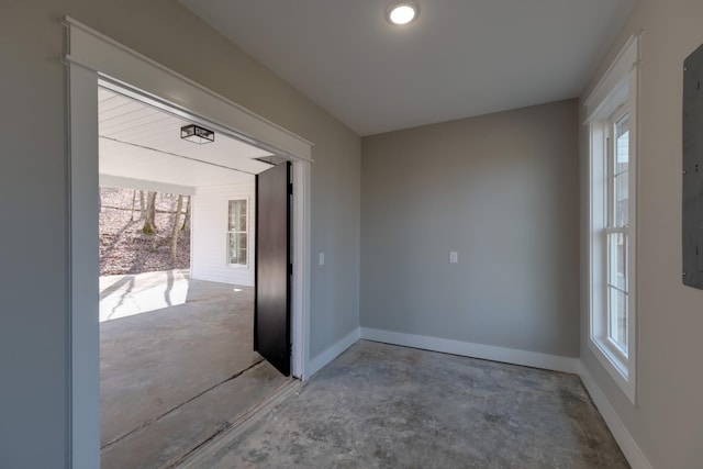 unfurnished room with concrete flooring