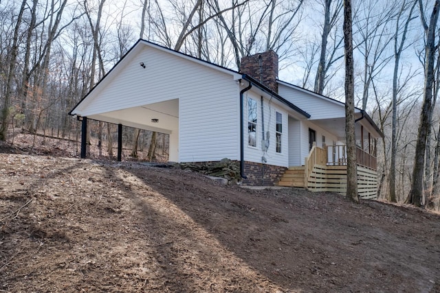 view of home's exterior featuring a carport