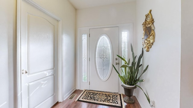 entryway with hardwood / wood-style flooring