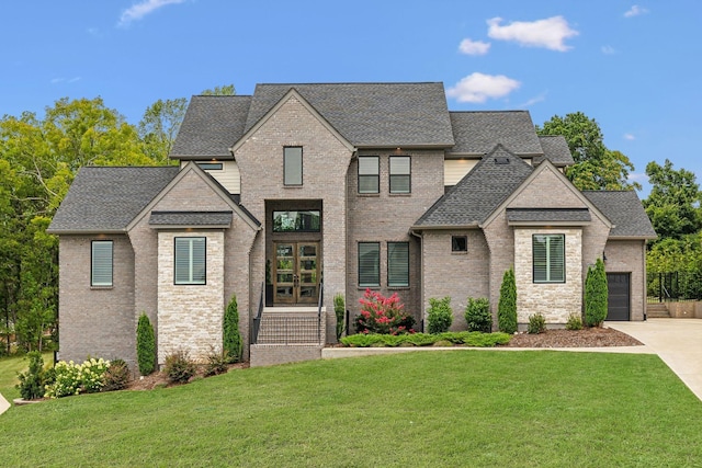 view of front of house with a garage and a front yard