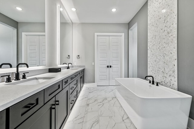 bathroom with vanity and a tub to relax in