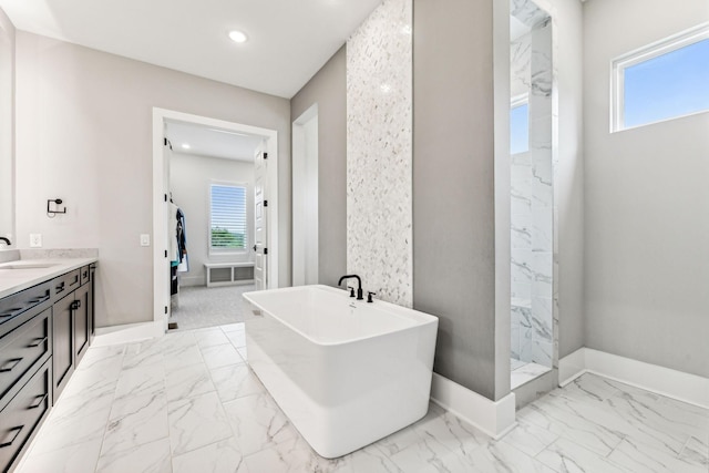 bathroom featuring independent shower and bath and vanity