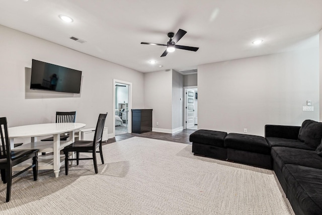 living room featuring hardwood / wood-style flooring and ceiling fan