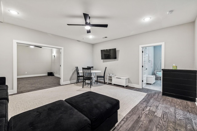 living room with hardwood / wood-style floors and ceiling fan