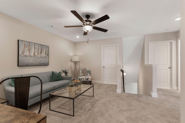 carpeted living room with ceiling fan