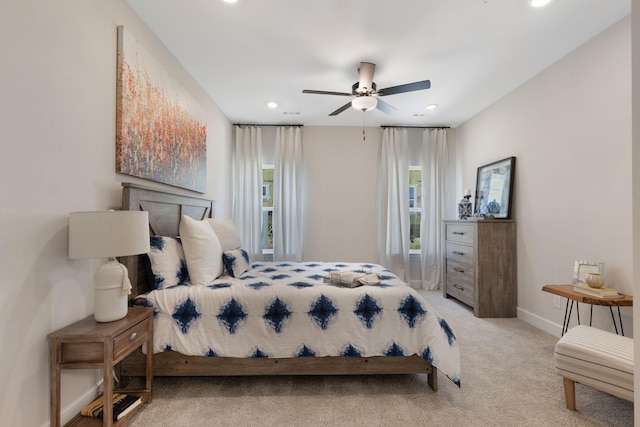 bedroom featuring light carpet and ceiling fan