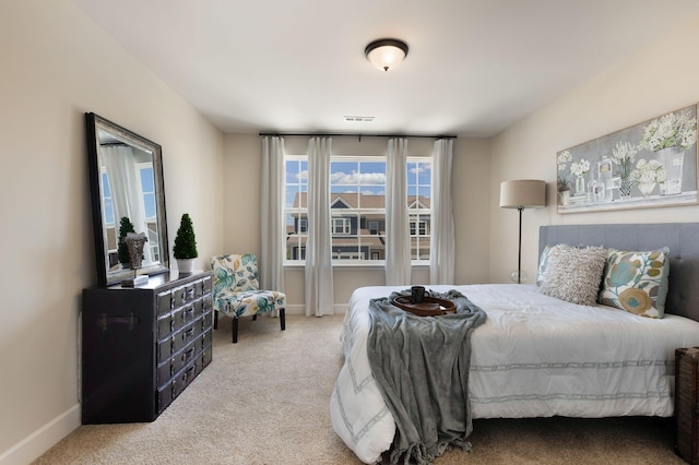 bedroom featuring light colored carpet