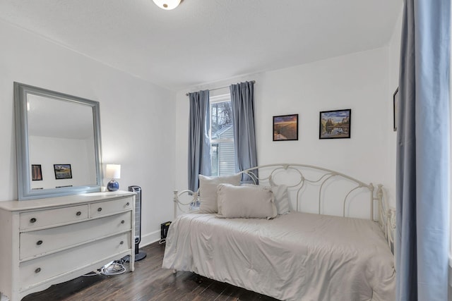 bedroom with dark wood-type flooring