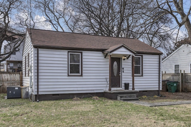 view of front of home with a front yard and central air condition unit