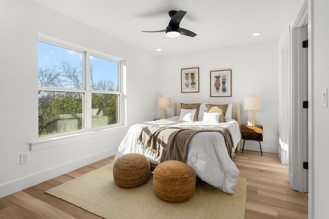 bedroom with light hardwood / wood-style floors and ceiling fan