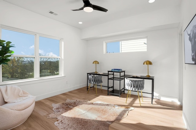 sitting room with hardwood / wood-style floors and ceiling fan