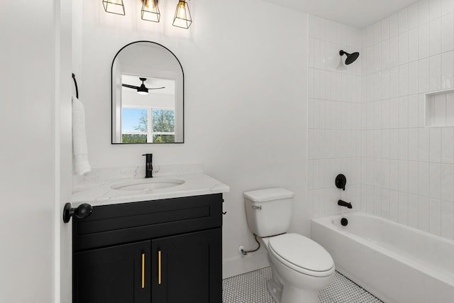 full bathroom featuring vanity, tiled shower / bath combo, and toilet