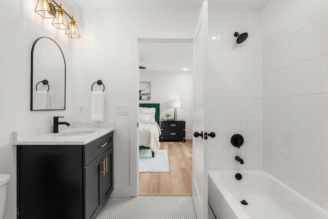 bathroom with vanity and tiled shower / bath combo