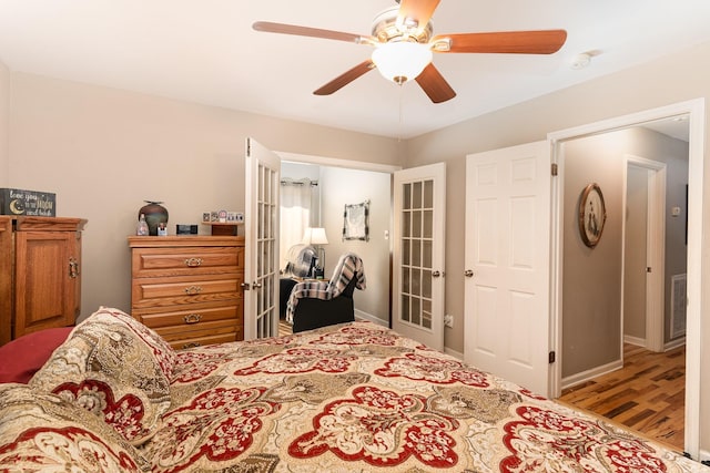 bedroom featuring french doors, ceiling fan, and light hardwood / wood-style floors