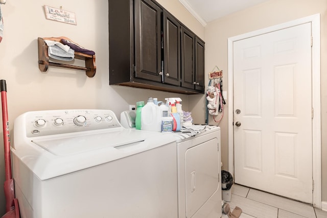 laundry area with cabinets, washing machine and dryer, and ornamental molding