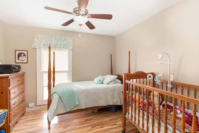 bedroom with ceiling fan and light hardwood / wood-style floors