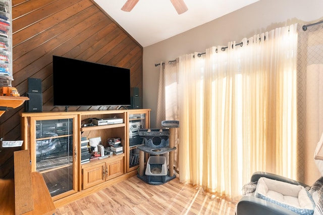 living room featuring ceiling fan, wood-type flooring, and lofted ceiling