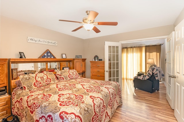 bedroom with french doors, ceiling fan, and light hardwood / wood-style flooring