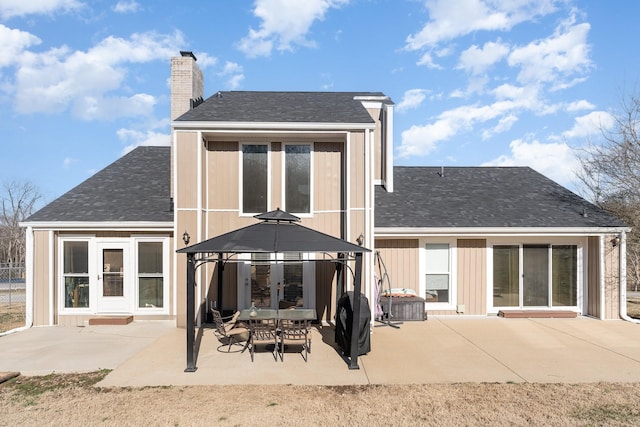 rear view of property featuring a gazebo and a patio