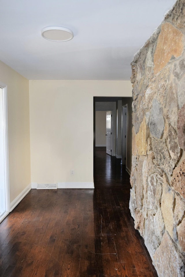 spare room featuring dark hardwood / wood-style flooring