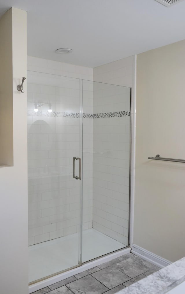 bathroom featuring walk in shower and tile patterned floors