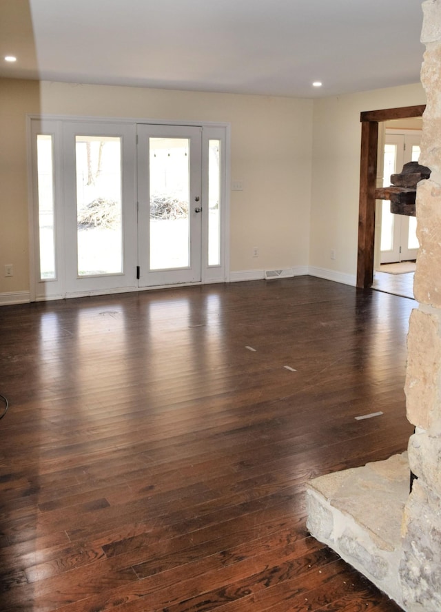 unfurnished living room featuring dark hardwood / wood-style flooring