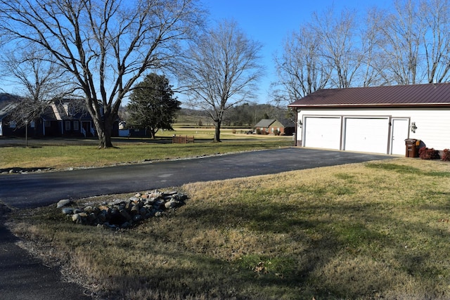 garage featuring a lawn