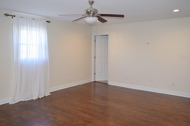 empty room with ceiling fan and dark hardwood / wood-style floors