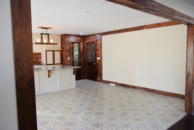 kitchen with decorative light fixtures, a kitchen breakfast bar, and a notable chandelier