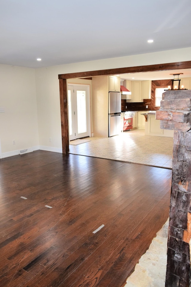 interior space with dark hardwood / wood-style flooring and a healthy amount of sunlight