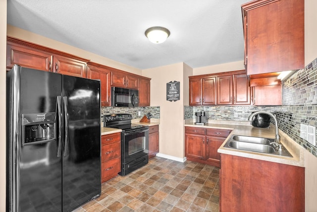 kitchen featuring tasteful backsplash, sink, and black appliances