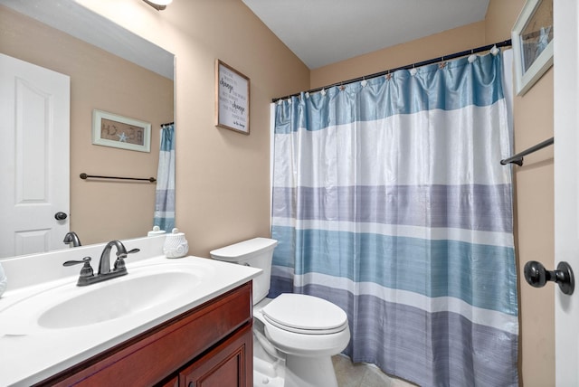 bathroom featuring vanity, toilet, and walk in shower