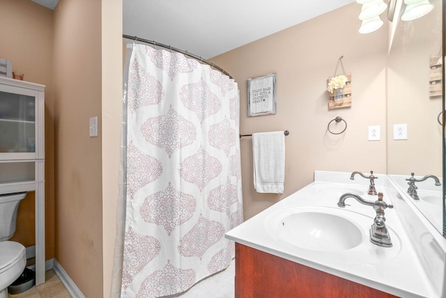 bathroom featuring a shower with curtain, vanity, and toilet