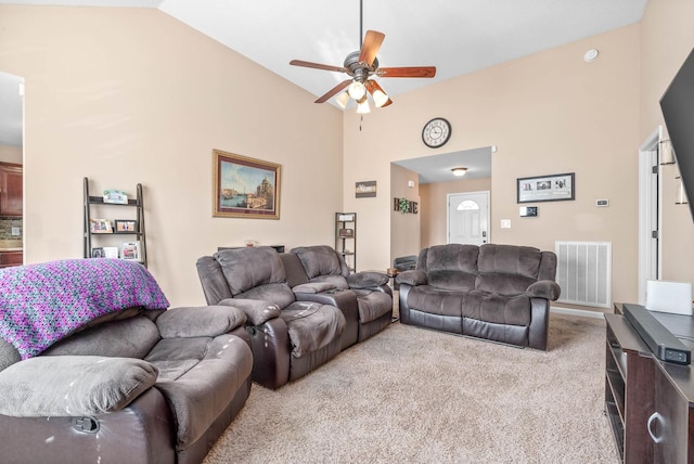 carpeted living room with vaulted ceiling and ceiling fan